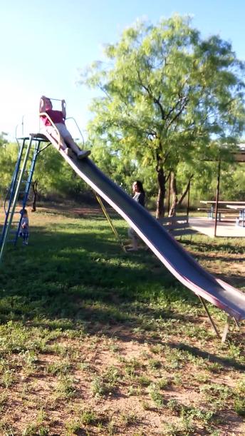 Grandma takes slide too fast, totally wipes out
