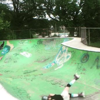 Rollerblading girl fails and slides down bowl